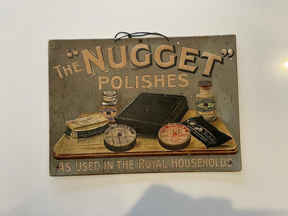 The Nugget Embossed Advertising Showcard. Grey background with embossed 3D graphics of shoe care 
