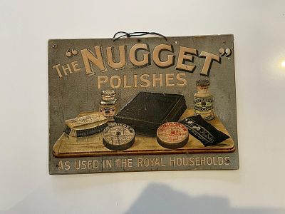 The Nugget Embossed Advertising Showcard. Grey background with embossed 3D graphics of shoe care 