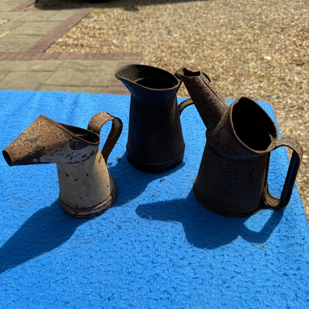 Lot 545: A Trio of Steel Oil Pourers and Measuring Jugs