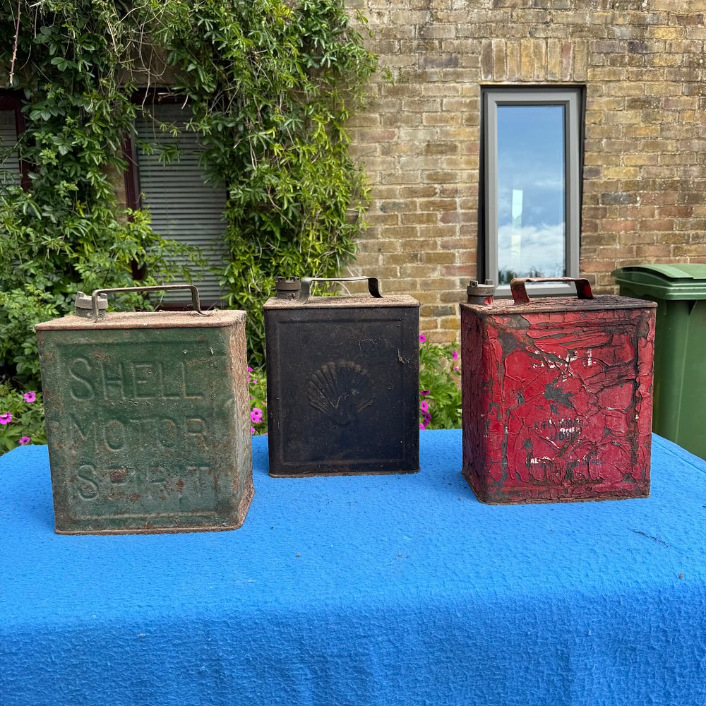Lot 566: Three Shell and Pratts Two-Gallon Petrol Cans