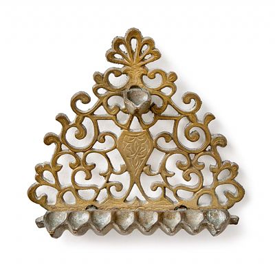 An old menorah made of cast brass. Width: 18 cm