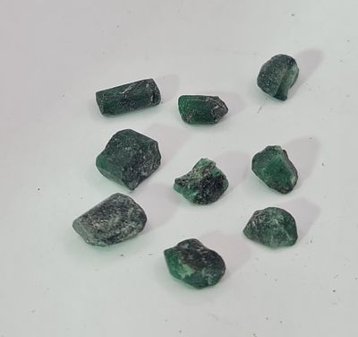 לוט 9 אבני אמרלד גולמיות לליטוש, משקל 75 קראט, הוצאו מבריפקה עם תג מחיר של 5$ לקראט 