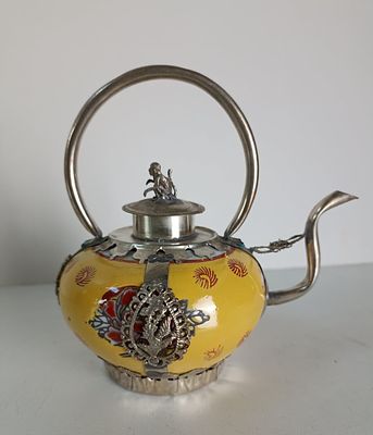 Китайский фарфоровый чайничек с изящными серебряными деталями, крышечкой, носиком и ручкой. 