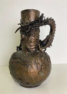 Старинная бронзовая ваза украшена высокохудожественным рельефным изображением дракона 