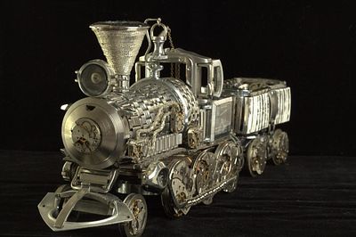 "Аллегория Времени и Прогресса" 
Л.Аракелян . Детали часовых механизмов. 
Высота 8/13/длина22см 