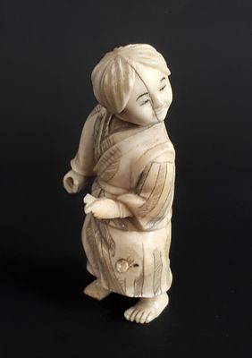 לאספנים. פסלון נצוקה יפני יפיפה, מחומר גרמי. דמות מביטה הצידה. בגדיה מעוטרים. חסר חלק שהדמות 