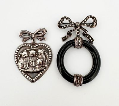 Two Sterling Silver Bow Brooches. Two sterling silver bow brooches, one with onyx and marcasite 