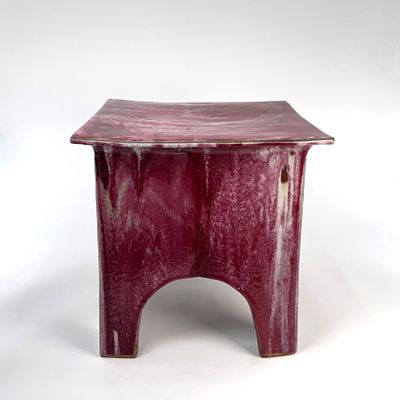 Ceramic Art Pottery Side Table. A contemporary stool featuring a red glaze with mottled 