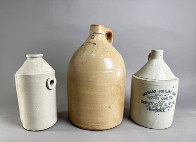 Three Stoneware Jugs. Three stoneware jugs including a American Bottling Corp jug, a Taunton 
