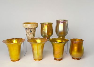 Seven Iridescent Glass Shades. Including two Tiffany favrile shades and five Quezal shades 
The 