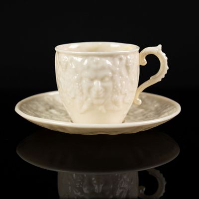 Belleek Mask Pattern Porcelain Teacup & Saucer. A Belleek 'Mask' pattern porcelain teacup and 