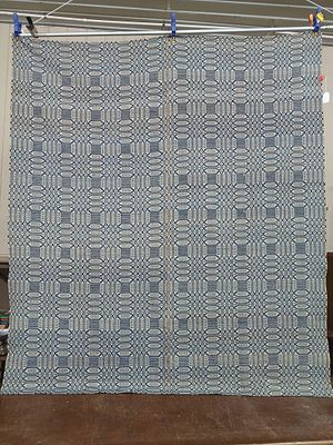 Cream & Blue Coverlet. Nice pattern with no large or major stains. A faint yellowing to edges