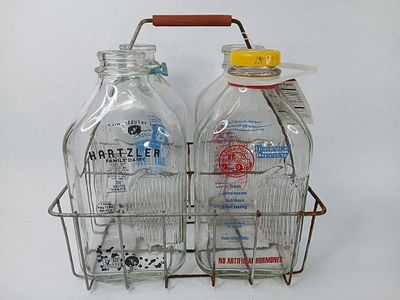 Half gallon milk bottles and wire carrier. clean bottles from 4 different dairies lawsons