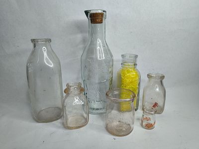 7 assorted glass milk bottles. includes a miniature valley gold milk bottle