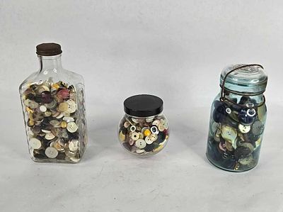 Blue jar and bottles filled with vintage buttons. .