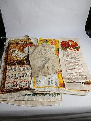 7 1960 -1970th cloth calendars and cloth sugar sack. largest calendar are 15x26