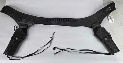 Black leather cartridge belt with dual pistol holsters. 40 to 45 belt size leather is a little 