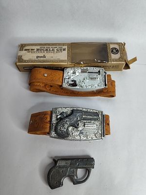 2 Remington derringer buckle gun belt set and multi pistol cap gun. .