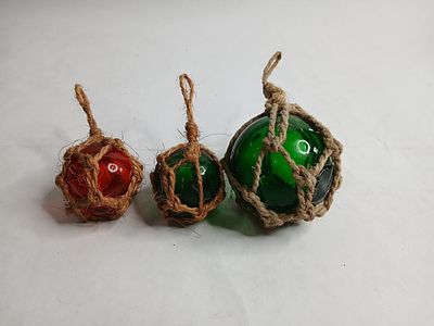 Green and red hand blown glass fishing buoy floats. larger floats is 3 in smaller one are 2 in