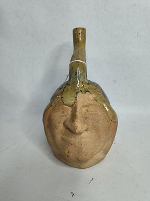 Clay pottery face jug. 7.5 in tall upper part is glazed