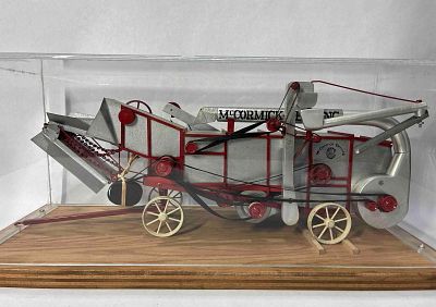 McCormick Deering Thrashing Machine. New toy Thresher presented in plexiglass case. Believed to 