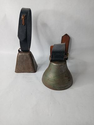Pair of Cattle Bell Collars. Each has a leather collar.