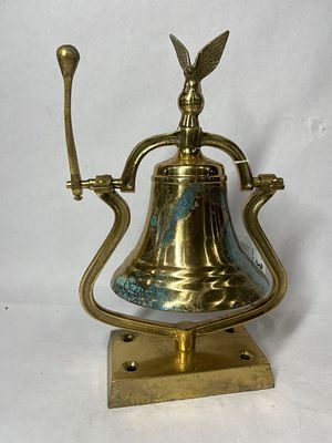 Brass Table Top Nautical RInger Bell. Oxidation shows to bell and base. WIth a spread eagle 