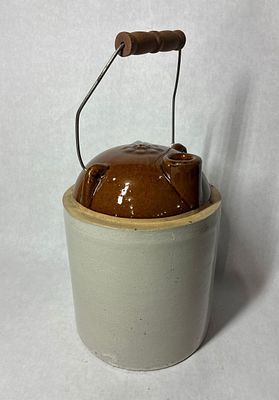 Two Tone Country Crock. Unique spout with flower vent hole to top. 10 inches tall. A few tiny 