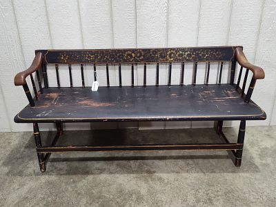 Very old low spindleback Deacon's Bench. In black paint with red undertones, hand-painted and 