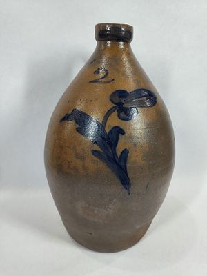 Decorated 2-gal stoneware jug. With a minor blemish on spout, otherwise is in great condition!! 