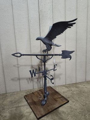 Cast metal Eagle weathervane. Mounted on a wooden base. Arrow is 29in long, 36in tall.