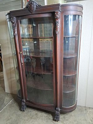 Beautiful 19th c McCreery & Co curved glass curio cabinet. Beautiful dark colored cabinet 