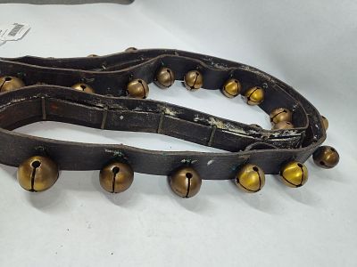 Strand of double throated brass sleigh bells. 30 bells on leather belt. All bells are similar in 