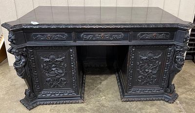 Highly Carved Antique Knee Hole Desk w/standing figural corners. With lion heads on top corners 