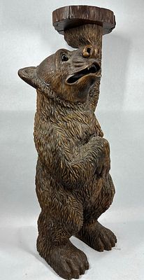 Carved Bear side table. Shows a crack in right foot, otherwise looks great! 31in tall.