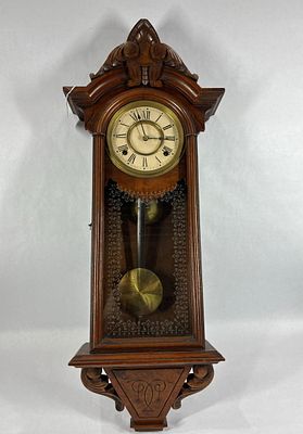Fancy early carved Wall Clock. Early windup clock, with pendulum, no key. 12in wide 30in long.