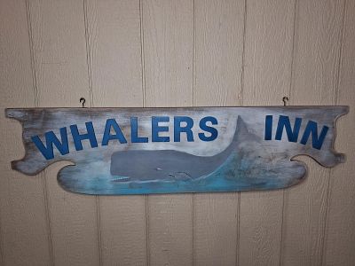 Whalers Inn wooden sign. 2-sided wooden sign with Tourist Rooms on other side. Newer sign but 