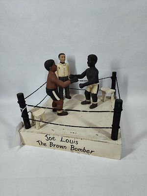 Joe Louis "The Brown Bomber" folk art boxing ring. Includes boxing ring, 2 carved wooden 