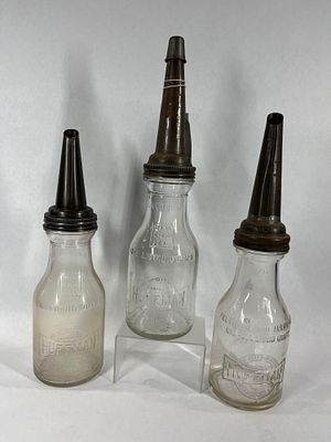 3- Huffman glass 1qt oil bottles. One is slightly different.