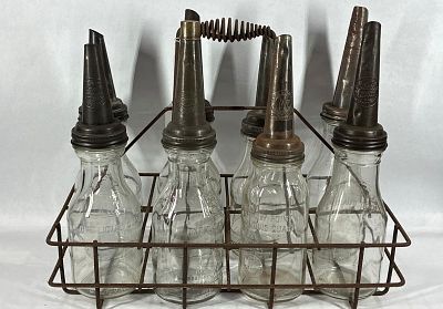 8- Various 1qt glass oil bottles with carrier. 5 are identical, other 3 are different.