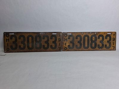 Pair of 1917 Ohio metal license plates. Painted metal plates with both having added holes along 