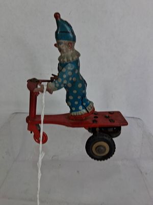 Tin Litho Roli Zoli Wind Up Clown on Red Scooter Budapest. Good overall condition showing 
