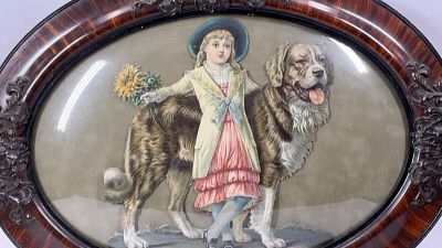 1880-1885 Chromolithograph. A hand cut girl with St Bernard.Vibrant color with a 3D effect. Oval 