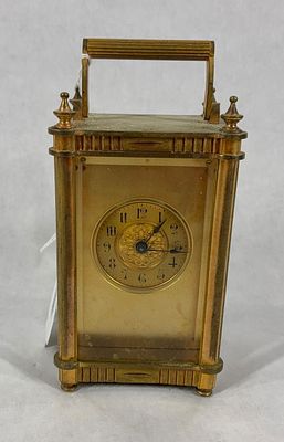 Antique Brass Carriage Clock. Gilt brass case with fluted columns and beveled glass panels. 