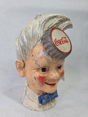 Coca-Cola Co. Sprite Boy Cast Iron Coin Bank by Xonex Co. showing areas of paint loss and 
