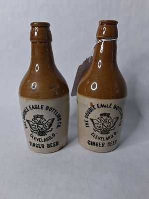 2 double Eagle bottling company Cleveland Ohio. Stoneware Ginger beer bottles. One has a chip 