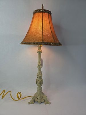 Cast iron ornate table lamp. In good working condition 26 in tall