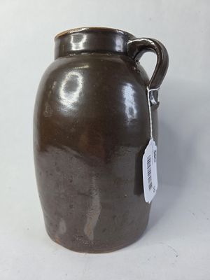 Brown glazed handled stoneware canning jar. Approximately 1/2 gallon. No chips or cracks 10 in tall