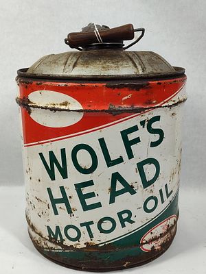Wolfs Head 5 Gal Motor Oil Can. Showing heavy wear due to age and usage