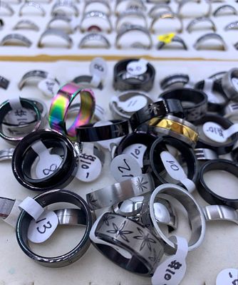 166 pc NOS Fashion Jewelry Rings. Many with size and price tags attached, size 16 to 5, openwork 